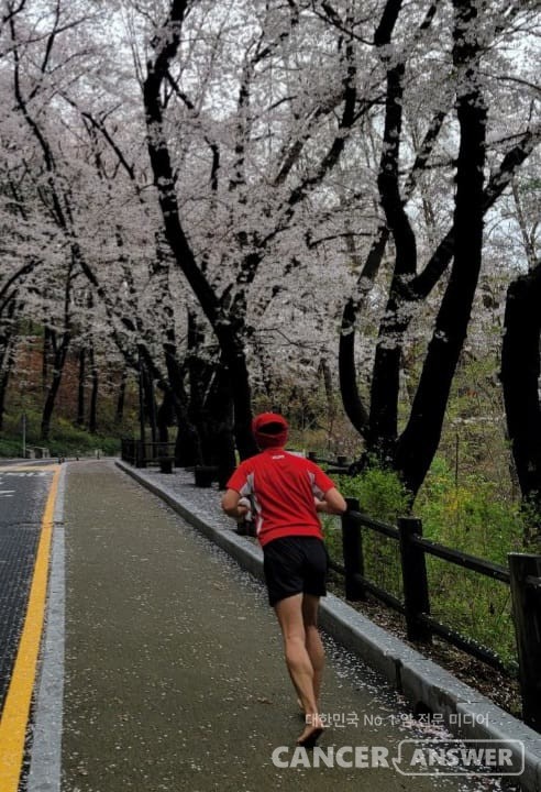 벚꽃 활짝 핀 한 달리기 훈련 코스에서 맨발로 달리고 있는 백우진 씨. / 페이스북 캡처