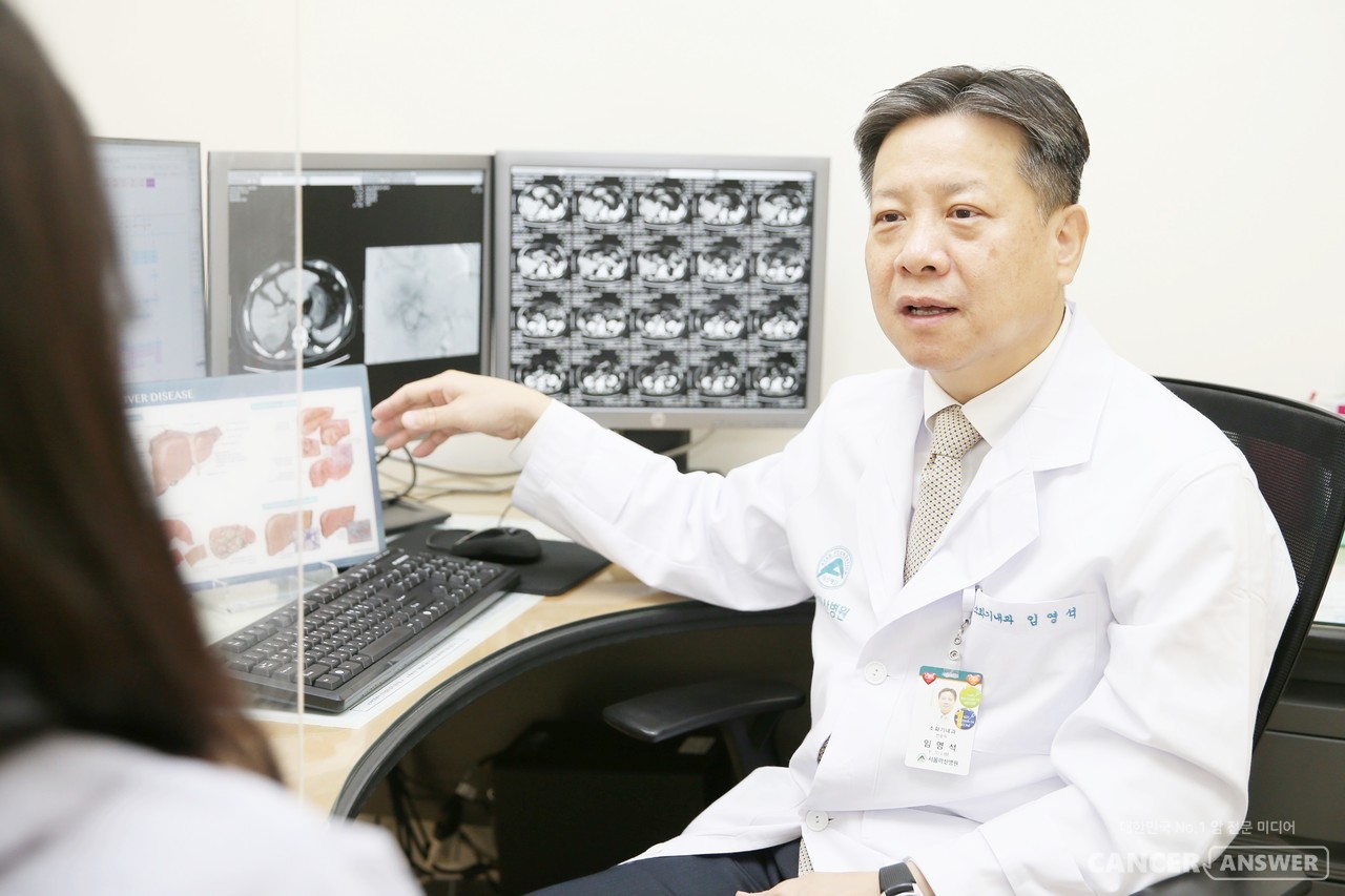 서울아산병원 소화기내과 임영석 교수팀이 기존의 B형간염 치료 지침과 달리 ‘간수치 상승이나 간경변 진행 여부와 관계없이 혈액 내 간염바이러스 수치에 따라’ 항바이러스 치료를 시작해야 간암으로 발전할 위험을 줄일 수 있다는 연구결과를 발표했다. 임영석 교수의 환자 진료 모습./서울아산병원 제공